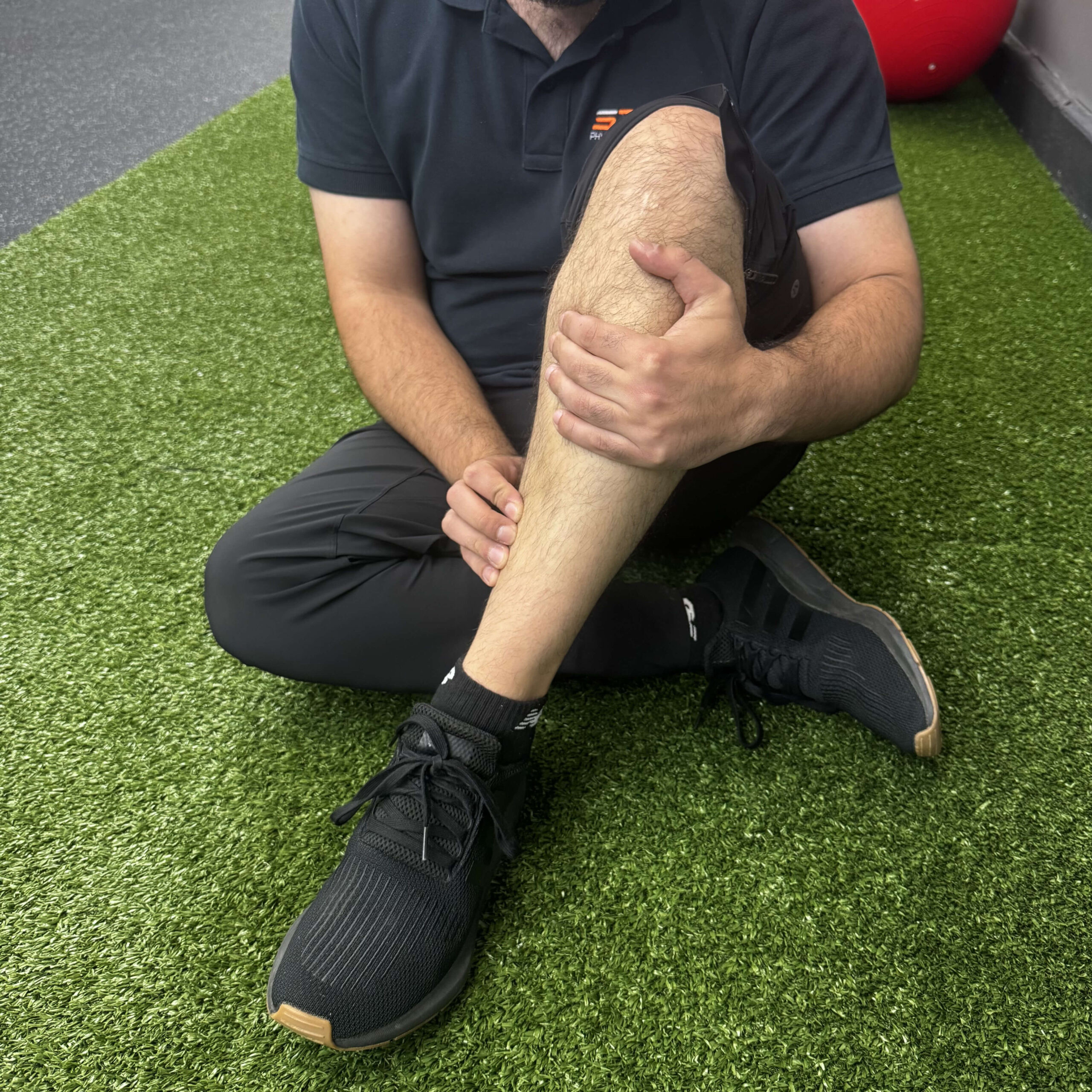 Runner holding lower leg with shin splint pain along the inside of the tibia